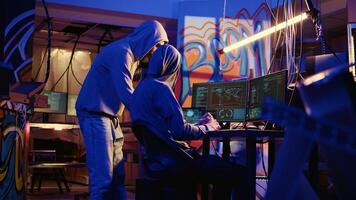 Spies in secret hideaway doing valuable data theft by hacking governmental websites with weak security. Cybercriminals using extensive technology knowledge to access valuable information illegally photo