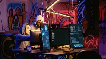 Hackers in dark room discussing ways to breach defenses and exploit weaknesses in PC systems. Evil computer scientists in hidden base getting past companies security networks photo