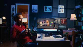 editor working for independent production company checking stills on camera gallery before inputting music, dialogues, graphics and effects over raw footage, editing clips for final project photo