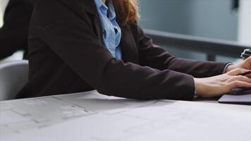 Interior designer studying architectural blueprints in office to translate accurate measurements of physical spaces in order to create new floor plan. CAD specialist working with drafts. Close up. photo