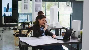 Sketch engineer meeting with contractor on videocall connection, discussing about scale measurements and draft elements before starting construction. Woman using online teleconference network. photo