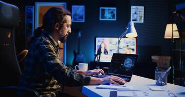 Data scientist updating artificial intelligence neural networks, writing complex binary code scripts. Teleworking freelancer in apartment office uses digital device programming to upgrade AI, camera B photo