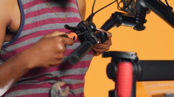 Close up shot of toolbox mechanical tools used by engineer to repair brake levers on bicycle handlebars, studio background. Woman utilizing screwdrivers and pliers to mend defective bike parts photo