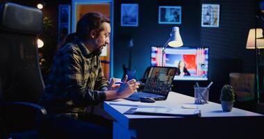 Remote employee making report to board of directors during company meeting on videocall. Man working from home participating in corporate remote videoconference call, presenting project, camera B photo