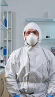 Lab technician in ppe suit working with virtual reality in chemical laboratory. Team of biologists examining vaccine evolution with high tech and technology researching treatment against covid19 virus photo