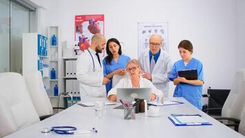 Brainstorming teamwork of physicians solving problem related to illnesses of patients in modern hospital conference room office. Medical examination, coworker consulting with mentor or chief physician photo