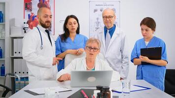 Doctors in lab coats working in hospital office discussing symptoms of disease for further treatment. Practical work of interns, medical examination, coworker consulting with mentor or chief physician photo
