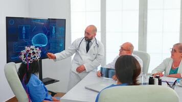 Female nurse wearing scaning headset for brain activity during experiment and doctor telling diagnosis. Monitor shows modern brain study while team of scientist adjusts the device in hospital office photo