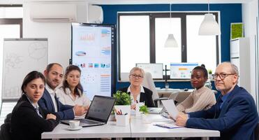 Pov of diverse team sitting in conference room during virtual meeting, discussing online with business partners. Internet conference call technology talk with investors, corporate brainstorming via web. photo