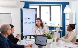 Mad angry start up owner debating screaming vivaciously in briefing asking for explication from diverse employees. Businesswoman raging about multitasking difficult job, screaming in boardroom photo