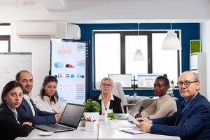 Pov of diverse team sitting in conference room during virtual meeting, discussing online with business partners. Internet conference call technology talk with investors, corporate brainstorming via web. photo