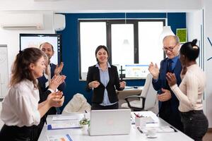 Happy creative business team having meeting in broadroom office victory overjoyed. Multiethnical partners coworkers celebrate successful teamwork result at company briefing photo