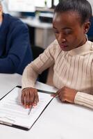 Start up team meeting with company leader planning financial strategy, analysing reports sharing paperwork. Executive director meeting shareholders in start up office, making satisfactorily agreement. photo
