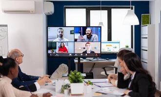 Team working by group call share ideas brainstorming negotiating use conference. Business people talking to webcam, do online conference participate internet brainstorming, distance office discussion. photo