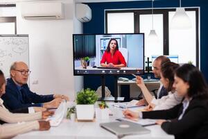 Manager woman sitting in front of camera talking on call during virtual conference working Business people talking to webcam, do online conference participate internet brainstorming, distance office discussion. photo