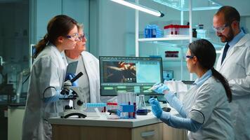 Scientist woman pipetting liquid to test tube working in equipped lab late at night. Chemists examining virus evolution using high tech for scientific analysis of treatment development against covid19 photo