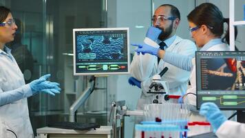 Team of medical researchers conducting vaccine development with help of high tech, test tubes, micropipette analysing results and planning next steps working at night in modern equipped laboratory photo