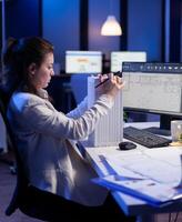 Engineer constructor designer architect developing prototype component in CAD program working in business office. Overworked woman studying new project model using innovative technology photo