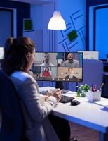 Start up manager working overtime late at night from business office talking online via web internet conference call with partners. Freelacner on videoconference corporate meeting using videocall chat photo