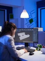 Software engineer working at digital cad project late at night in office company. Woman entrepreneur looking at technical construction before deadline using modern technology network photo