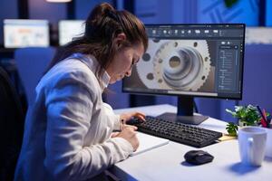 Woman engineer architect working in modern cad program sitting at desk in start-up business office. Industrial employee start new prototype idea on computer using inovative design concept photo