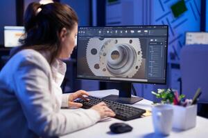 Woman engineer working on new digital prototype using professional construction equipment late at night at office company. Entrepreneur looking at technical architecture before deadline photo