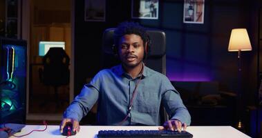 Gamer discussing with audience multiplayer game match winning strategies during livestream. Content creator chatting with viewers, presenting ways of being victorious in esports tournaments photo
