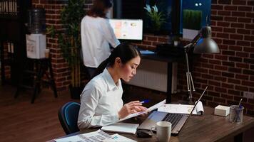 Employee writing important emails at computer desk, finalizing deal with business associates. Businesswoman doing b2b networking over internet with prospecting clients, typing on laptop photo