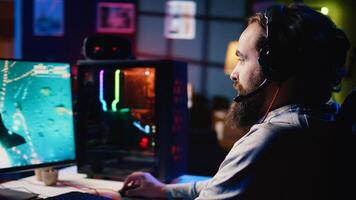 Happy man using headphones to play spaceship flying singleplayer game with overlay HUD showing health, fuel, ammo bars and minimap. Smiling gamer immersed in gaming experience, navigating universe photo