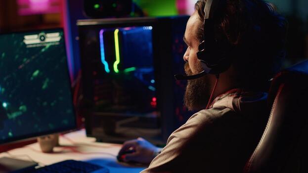 Close up shot of computer screen showing spaceship flying singleplayer game with overlay HUD showing health, fuel, ammo bars and minimap. Man playing space exploration simulation game photo