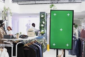 Empty green screen mock up advertising shoes new collection in fashion boutique. Blank chroma key interactive display for promotion and stiletto showcasing for clients in mall photo