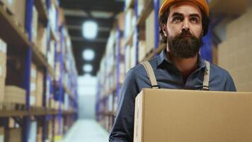 Loader checks orders and loads industrial merchandise into boxes, filling in cargo containers with the specified requirements. Depot staff member preparing outgoing deliveries and shipments. photo