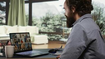 Company CEO meets with shareholders on videocall, attending online connection for new briefing session at his luxurious villa in the mountains. Entrepreneur explaining global strategies to his team. photo