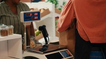 African american customer preparing to buy organic produce from local supermarket, supporting sustainable lifestyle and small business vendor. Buyer approaching checkout counter. photo