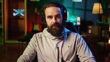 Streamer greeting audience, filming tutorial on how to defeat enemies in multiplayer game, zoom out shot. Close up on professional gamer playing videogame, teaching fans esports strategies photo
