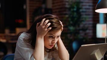 Worker frustrated by mistake she made while inputting data on laptop while working on company project overnight. Close up shot of upset businesswoman realizing error she made photo