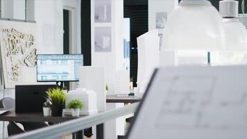 Empty engineering office equipped with industrial gear and architectural details, shared workspace area for startup company. 3D construction models, project plans and visual program tools. photo