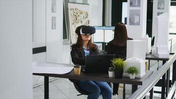 Woman architect working with vr glasses in startup office, modeling floor plan or house blueprint using metaverse artificial intelligence. Industrial engineer developing architectural lines. photo