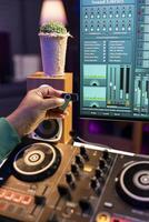Professional artist inserting an usb stick in the computer to edit songs on his daw software, working in music industry post production. Young composer producing songs, adjusting recordings. Close up. photo
