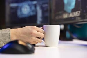 Man at home enjoying hot beverage, witnessing AI becoming sentient, asking questions about itself. Close up of man holding coffee mug, talking with artificial intelligence becoming self aware photo