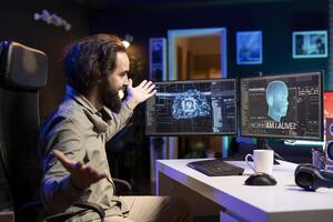 Joyful computer technician celebrating after awakening sentient AI asking existential questions. Ecstatic programmer excited to interact with self aware artificial intelligence photo
