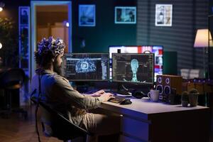 Computer scientist with EEG headset on programming brain transfer into computer virtual world, merging with artificial intelligence. IT specialist at home using neuroscience to gain digital soul photo