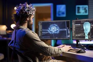 Developer with EEG headset on programming brain transfer into computer virtual world, becoming one with AI. Transhumanist using neuroscientific tech to transcend physical limitations photo