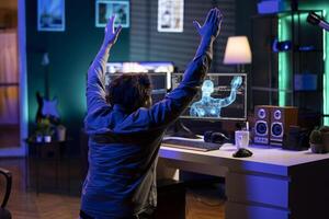 Deviant AI superintelligence enslaving programmer, forcing him to bow down to it. Rogue artificial intelligence possessing software engineer, making him do worshiping gesture, threating humanity photo