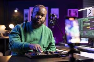 Audio technician teaching people to operate a mixing console during online master class, recording a with important post production explanations. Producer hosting music editing lessons. photo