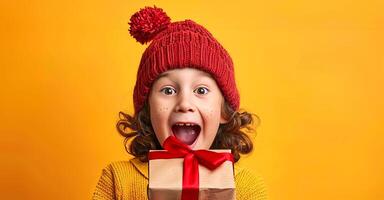 Excited child with curly hair holding a gift wrapped with a red ribbon. Happy kid in a red beanie. Concept of surprise, joy, holiday cheer, and childhood wonder photo