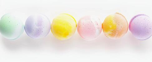 Assorted colorful bath bombs isolated on a clean white background. Pastel-colored bath bombs arranged in a row. Concept of self-care, bathing essentials, and home spa photo