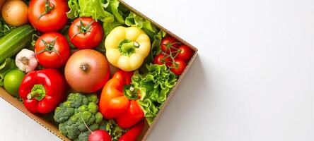 Assorted fresh vegetables in a cardboard box on a white textured background. Concept of healthy eating, organic food delivery, nutrition, fresh produce. Copy space photo