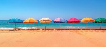 Vibrant umbrellas along coastal landscape. Row of colorful umbrellas on beach. Concept of sunshade, seaside leisure, family vacation, and tourist spot. Banner. Space for text photo