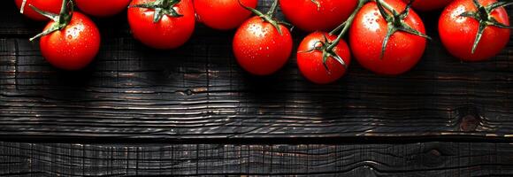 Red ripe tomatoes with stems on rustic wooden background. Fresh tomatoes, organic vegetables, healthy food, nature concept. Banner. Copy space photo